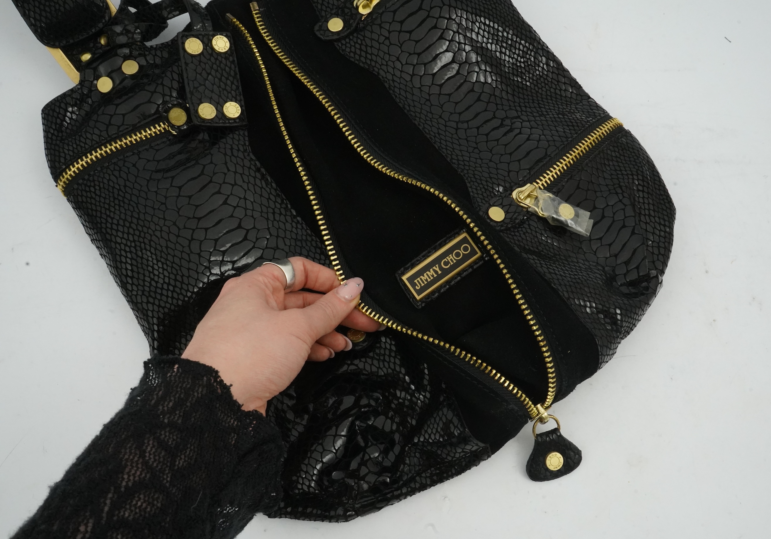 A vintage Jimmy Choo black snakeskin and elasticated material handbag with zip detail.